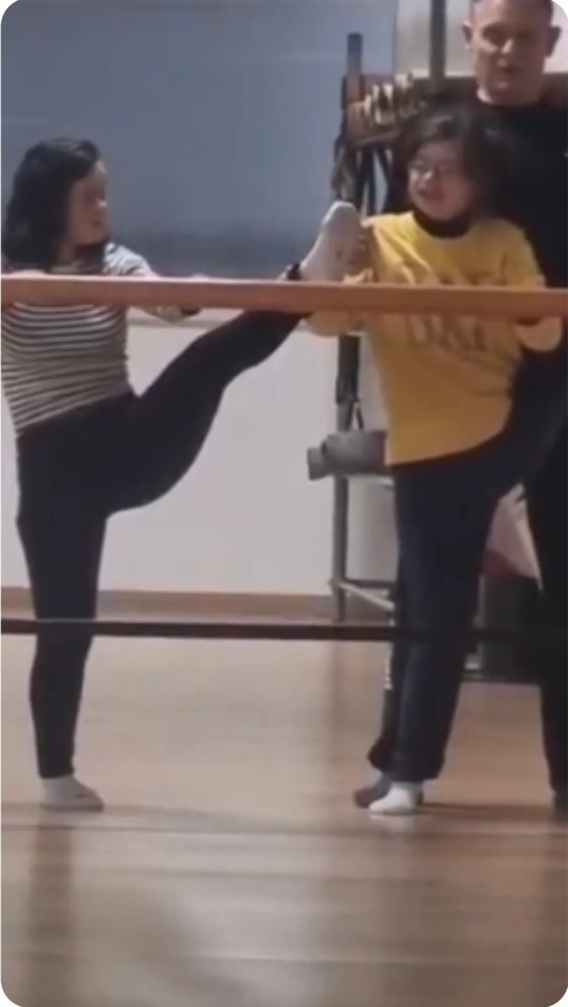 Coach guiding a child through a balance exercise