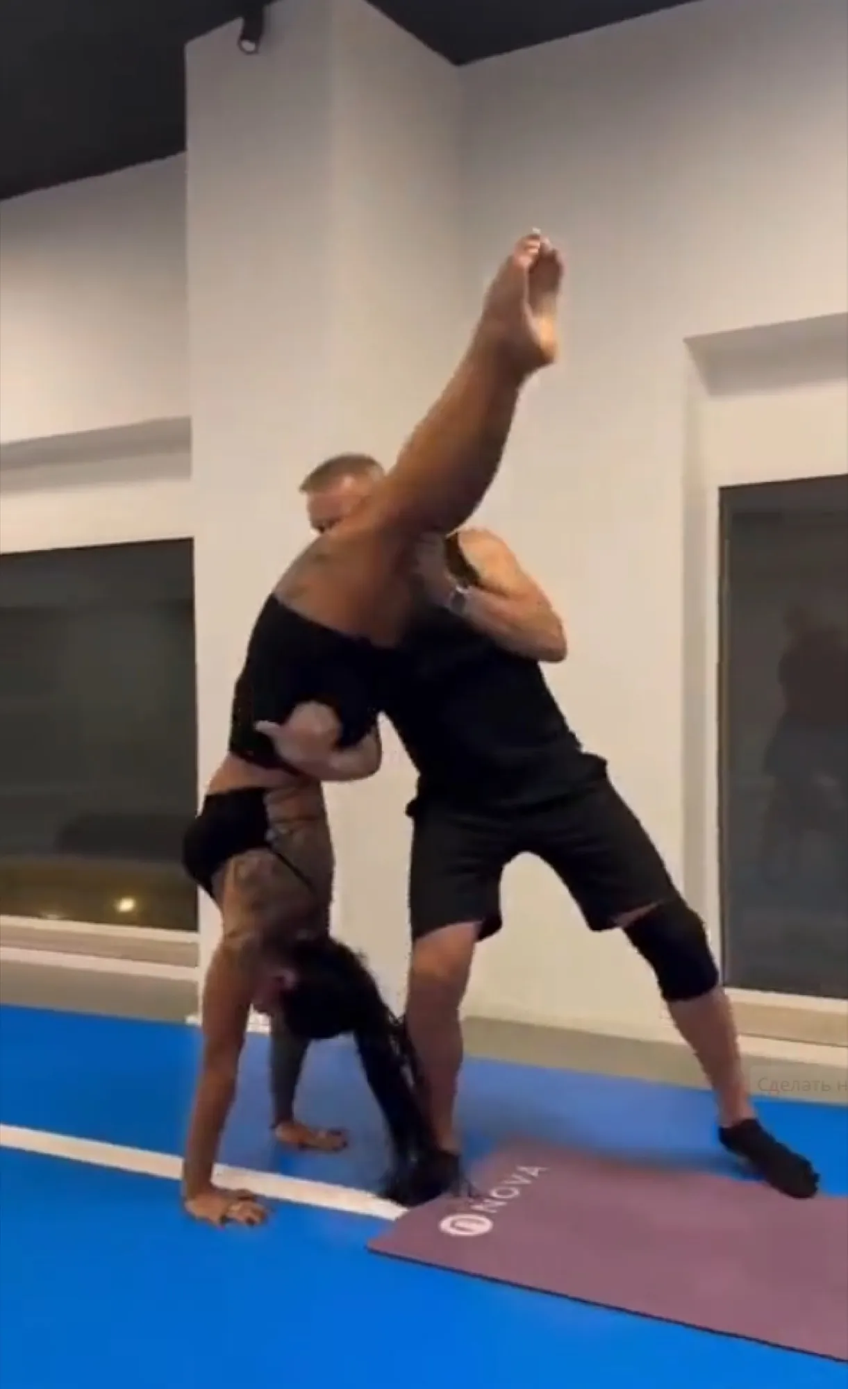 Coach assisting a child with a handstand