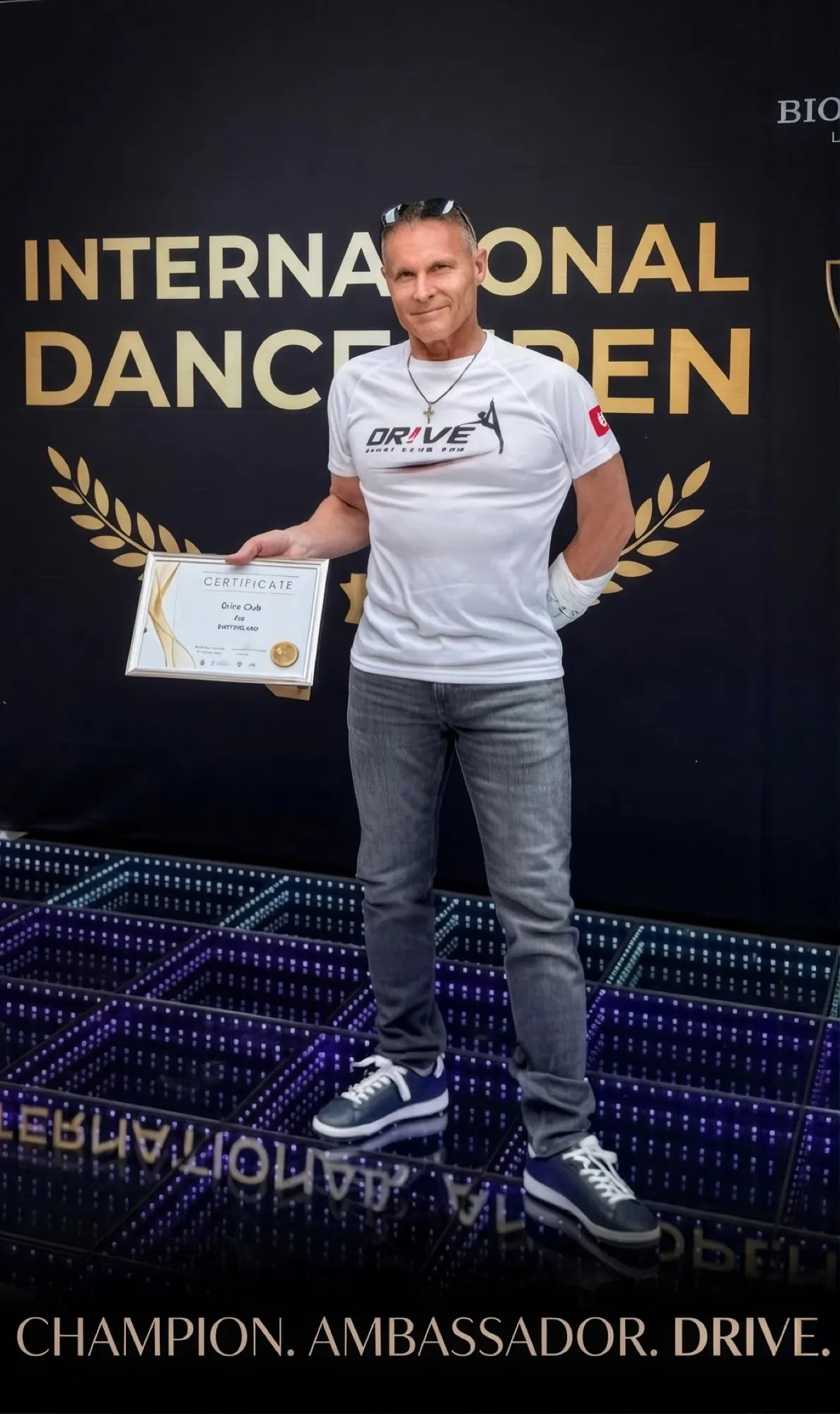 Igor Matyushenko holding a certificate at the International Dance Open